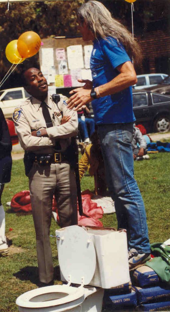 Michael Delacour talking with police officer in People's Park