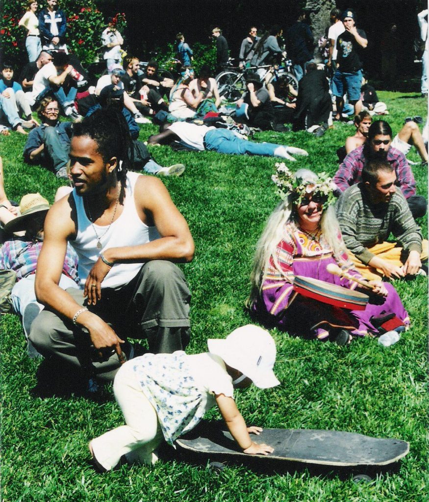 People's Park gathering on the sunny lawn for music and speakers